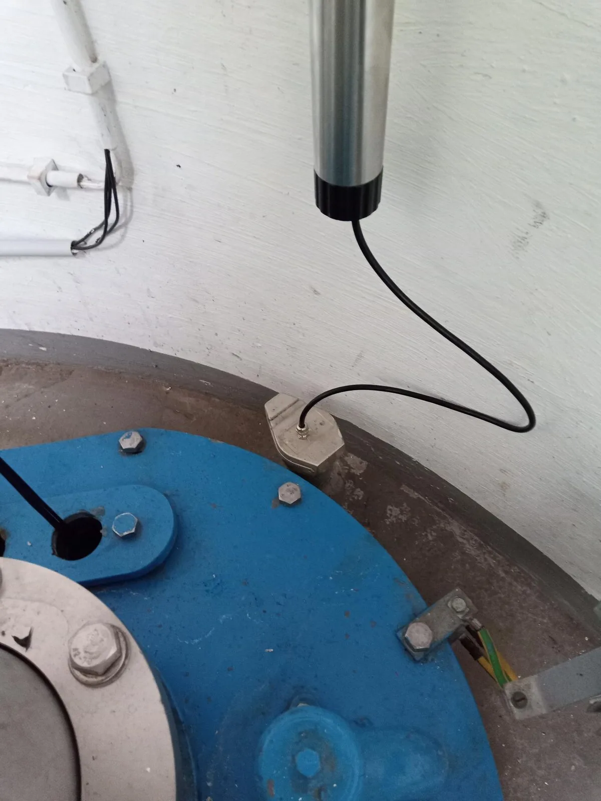 Datenlogger und Sondenleitung an einer Brunneninstallation.